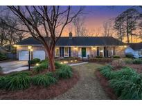 Charming brick home with a well-manicured front yard and inviting green front door at 110 Dunbury Dr, Summerville, SC 29485