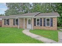 Charming brick home with a well-maintained lawn and black shutters at 112 Pine Grove Dr, North Charleston, SC 29420