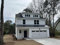 Charming two-story home with white siding, black trim and a two car attached garage at 1817 Edgewood Dr, Charleston, SC 29407