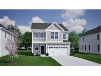 Charming two-story home featuring a second story balcony, a well-manicured lawn, and an attached two-car garage at 222 O'Leary Circle Dr, Summerville, SC 29483