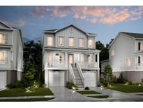 Charming two-story home featuring double garages, covered porch, and manicured landscaping at 2280 Minfarm Way # 529, Mount Pleasant, SC 29466