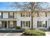 Traditional-style two-story townhouse with neutral siding and black shutters, showcasing its charming curb appeal at 2494 Etiwan Dr # 3D, Charleston, SC 29414