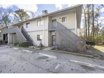 Inviting condo with gray siding, decorative lattice, and stairs to the second level, providing a charming curb appeal at 2741 Jobee Dr # 4, Charleston, SC 29414