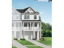 Charming two-story home with white siding, a porch and lush greenery at 416 Katies Scenic Ct, Charleston, SC 29492