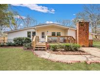 Charming one-story home featuring a cozy front porch, brick chimney, and landscaped front yard at 847 Quail Dr, Charleston, SC 29412