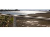 Relaxing balcony view with marsh and water views through a screen porch with stainless steel cable railing system at 102 Mariners Cay Dr, Folly Beach, SC 29439