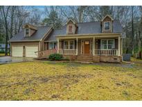 Charming two-story home with a welcoming front porch, well-manicured yard, and attached two-car garage at 112 Ravenswood Ct, Summerville, SC 29485