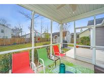 Relaxing screened patio features colorful chairs and a view of the backyard and storage shed at 140 Satur Dr, Goose Creek, SC 29445