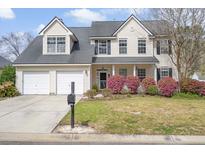Charming two-story home featuring a well-manicured front yard and a welcoming front porch at 1458 Clarendon Way, Mount Pleasant, SC 29466