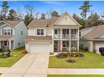 Charming two-story home with a welcoming front porch, well-manicured lawn, and attached two-car garage at 146 Brant Dr, Summerville, SC 29483