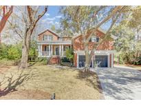 Charming two-story brick home with a welcoming front porch and a two-car garage at 1540 Strathmore Ln, Mount Pleasant, SC 29464