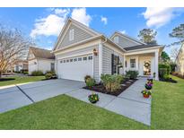 Charming single-Gathering home features a two-car garage, manicured landscaping, and a welcoming front porch at 157 Sea Lavender Ln, Summerville, SC 29486