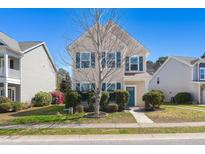 Charming two-story home with blue shutters and a manicured lawn at 1818 Towne St, Johns Island, SC 29455