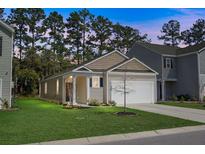 Charming single-story home with a well-manicured lawn, attached garage, and inviting curb appeal at 212 Sweet Cherry Ln, Summerville, SC 29486
