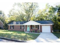 Charming one-story brick home with a well-manicured lawn and inviting curb appeal at 380 Furman Ln, Ladson, SC 29456