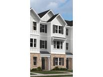 New townhome exterior with white siding, brick accents, and black shutters at 5120 Double Eagle, Summerville, SC 29485