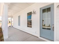Charming front porch with a light blue door and white siding, offering a welcoming entrance to the home at 796 Clay Field Trl, Summerville, SC 29485
