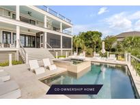 Luxury home featuring a private pool with sun loungers and lush landscaping, perfect for outdoor relaxation and entertaining at 1126 Ocean Forest Lane, 1/8 Share, Seabrook Island, SC 29455