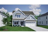 Charming two-story home with a manicured lawn, attached garage and blue siding at 125 Crosscut Ln, Summerville, SC 29486