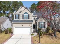Charming two-story home with manicured lawn, attached garage, and lovely landscaping at 1441 Thayer Pl, Mount Pleasant, SC 29466