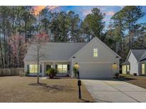 Charming single-story home with well-maintained lawn, two-car garage and inviting curb appeal at 1473 Coopers Hawk Dr, Hanahan, SC 29410