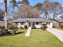Charming single-story home with lush green lawn and mature trees in a desirable neighborhood at 1950 Culver Ave, Charleston, SC 29407