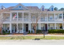 Charming townhomes with covered front porches, decorative columns, and well-maintained landscaping at 2416 Kings Gate Ln # 403, Mount Pleasant, SC 29466
