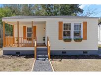 Charming cottage-style home featuring a covered front porch and decorative shutters at 2714 W Surrey Dr, North Charleston, SC 29405