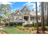 Charming two-story home with a covered porch and lush landscaping at 4 Falcon Point Rd, Kiawah Island, SC 29455