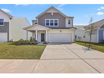 Charming two-story home featuring a two-car garage and manicured front lawn at 4497 Ocean Farm Dr, Summerville, SC 29485