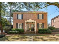 Charming brick two-story home with black shutters, manicured landscaping, and a welcoming entrance at 51 Gadsden St # B, Charleston, SC 29401