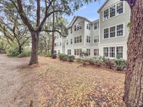 Multi-story home with well-maintained landscaping and mature trees providing shade at 60 Fenwick Hall Allee # 314, Johns Island, SC 29455