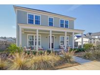 Charming two-story home with a welcoming front porch and well-manicured landscaping at 643 Blueway Ave, Summerville, SC 29486