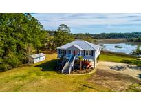 Charming coastal home featuring a metal roof, elevated design, and picturesque water views at 7805 Seafield Rd, Yonges Island, SC 29449