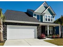 Charming two-story home featuring a two-car garage, stone accents, and a manicured lawn at 804 S Pointe Blvd, Summerville, SC 29483