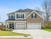 Charming two-story home with a well-manicured lawn and a two-car garage at 1114 Donerail Ln, Johns Island, SC 29455