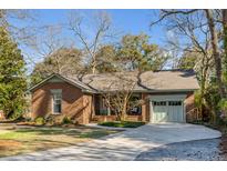 Charming brick home with a well-manicured lawn, a paved driveway, and inviting curb appeal at 1228 Penny Cir, Mount Pleasant, SC 29464