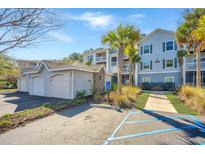 Inviting condo complex with multiple garages, mature landscaping, and accessible parking on a bright, sunny day at 1300 Park West Blvd # 418, Mount Pleasant, SC 29466