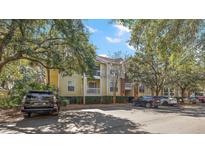 Apartment building featuring trees, parking spaces, and balconies at 1600 Long Grove Dr # 1313, Mount Pleasant, SC 29466
