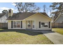 Charming single-story home featuring a manicured lawn and inviting entrance with dark shutters at 203 Birmingham Dr, Summerville, SC 29486