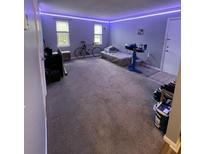 Spacious bedroom features carpet, a bicycle, natural light from the windows and vibrant LED accent lighting at 21 Rivers Point Row Row # 17 B, Charleston, SC 29412