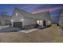 Charming home with a well-manicured lawn, attached garage, and inviting front porch at 220 Garden Gate Way, Summerville, SC 29486