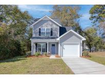 Charming two-story home featuring gray siding, a one-car garage, and well-maintained landscaping at 2280 Bailey Dr, Charleston, SC 29405