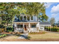 Charming two-story home with a welcoming front porch and beautifully landscaped yard at 34 Avondale Ave, Charleston, SC 29407