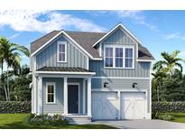 Charming two-story home featuring a two-car garage, light blue siding, and a well-manicured lawn at 365 Trailmore Ln, Summerville, SC 29486
