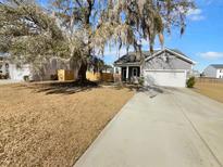 Charming single-Gathering home with a two-car garage and a traditional design on a large lot with a mature tree at 431 Eva St, Moncks Corner, SC 29461