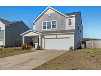 Charming two-story home with a two-car garage and manicured lawn at 458 Pender Woods Dr, Summerville, SC 29486