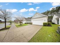 Charming single-story home featuring a two-car garage and well-maintained front lawn in a suburban neighborhood at 523 Eastern Isle Ave, Summerville, SC 29486