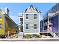 Charming two-story home with light green siding and white trim, showcasing its inviting curb appeal at 108 Smith St # 108-D, Charleston, SC 29403