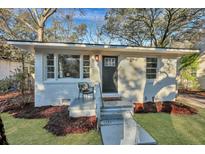 Charming single-story home with painted white brick and inviting front yard landscaping at 1251 Wisteria Rd, Charleston, SC 29407